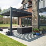 External garden shot of a louvered roof pergola attached to a property