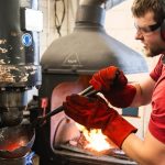 Armourer crafting a steel helmet at Lancaster Armoury Workshop