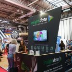 Insight Data stand at FIT Show 2025 featuring a darts competition and live visitor engagement