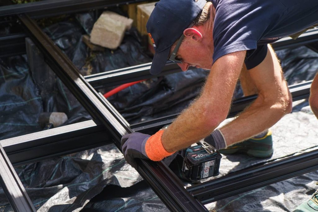 Designer Exteriors’ Matt Burgon installing the Outdure® Qwickbuild® frame system from F.H. Brundle.