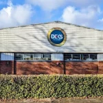 DEKS by Design headquarters building with the DEKS logo displayed on the front exterior.