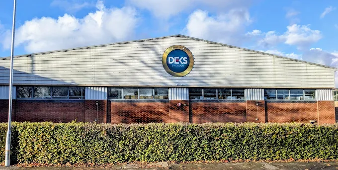 DEKS by Design headquarters building with the DEKS logo displayed on the front exterior.